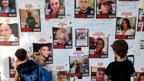 Messages left on a wall in Tel Aviv showing the portraits of Israeli hostages held by Palestinian Hamas gunmen. Israel and Hamas agreed Wednesday to a four-day cease-fire.