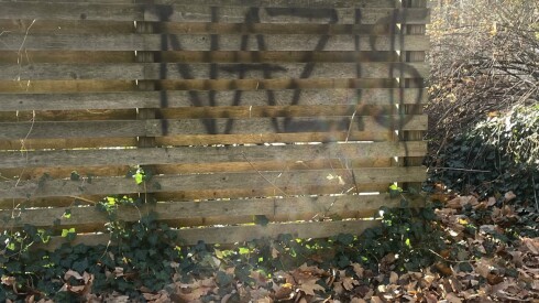 The word “Nazis” is seen spray-painted on a wooden fence surrounded by trees at a Michigan home owned by Rahm Emanuel.