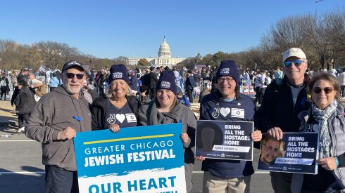 A group from Temple Beth Israel in Skokie attends the March for Israel on the National Mall in Washington. Pictured from left, with the U.S. Capitol building behind them as they carry signs and wear hats declaring their support, are Michael Lorge, Lori Sagarin, Rabbi Rachel Marks, Andy Glock, Cindy Franklin and Steve Franklin.